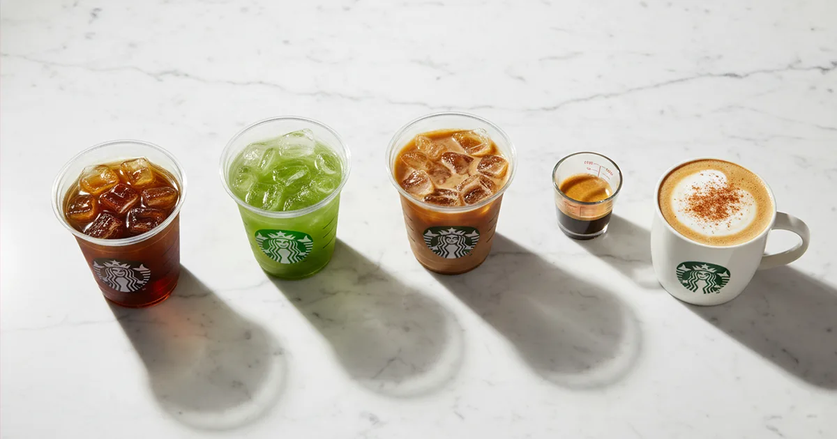best low calorie Starbucks drinks arranged flat lay on white marble background